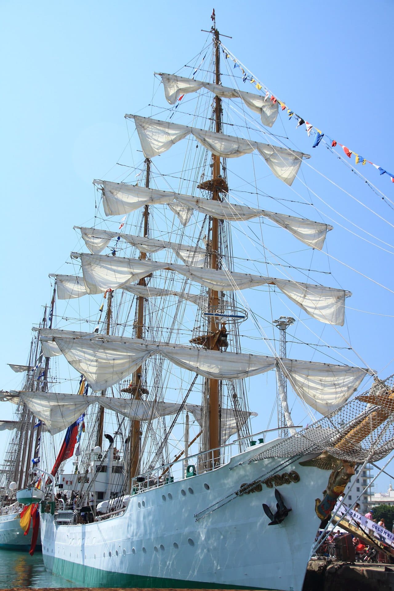 El Juan Sebastián de Elcano atracado con las velas desplegadas y empavesado